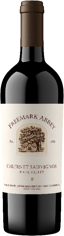 Bottle of Freemark Abbey Cabernet Sauvignon Napa Valley red wine with a dark ruby color and a label featuring an illustration of a grape cluster and oak barrels.